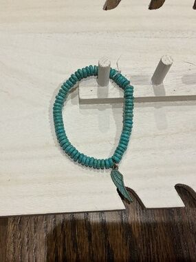 A teal wing bracelet